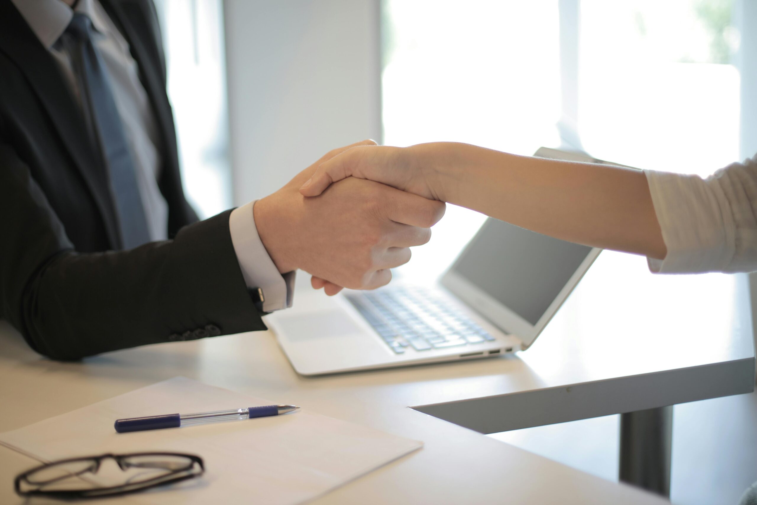 Business handshake symbolising trusted partnership between Crawford Consultancy and its clients